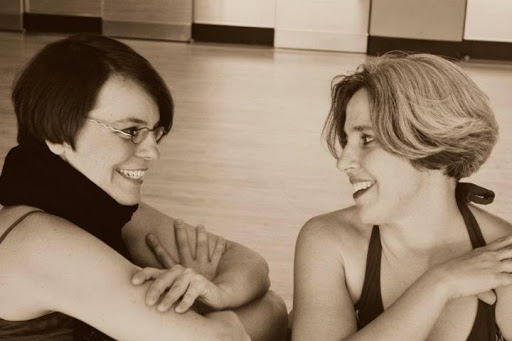Nicole Harris and karen Krolak are sitting next to each other in a dance studio talking about ideas for a movement phrase